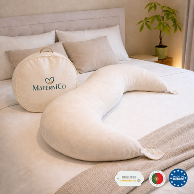 MaterniCo 5-in-1 maternity pillow, on a bed with the branded carry bag